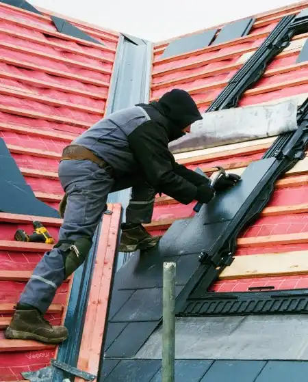 Roofer Replacing Tiles on a House Roof